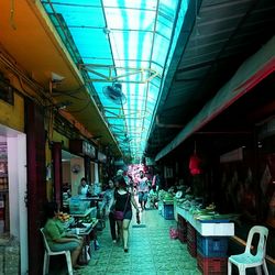 Empty road along illuminated lights