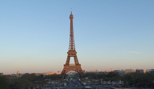 Tower and buildings in city against sky