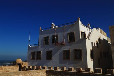 Low angle view of building against clear blue sky