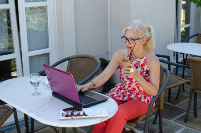 Woman working with technology outside an office