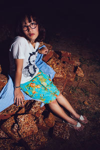 High angle view of woman looking away while sitting on land