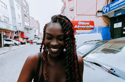 Portrait of young woman on street in city