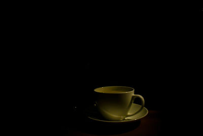 Close-up of coffee cup against black background