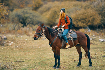 Horse riding horses on a field