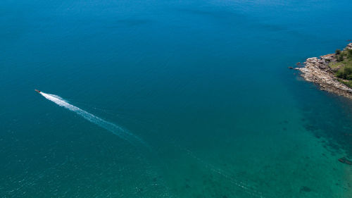 High angle view of sea against blue sky