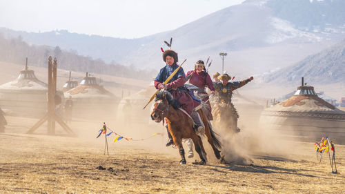 People riding horse in mountains