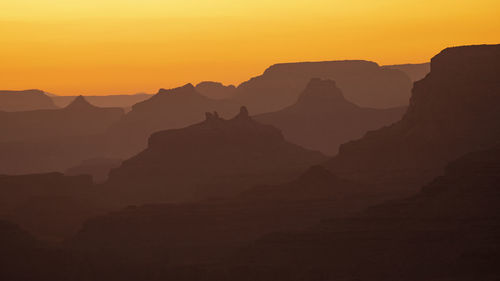 Scenic view of silhouette mountains against sky during sunset