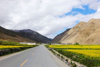 Empty road along countryside landscape