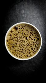 Close-up of coffee cup against black background