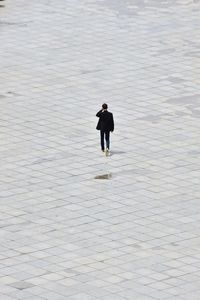 Full length rear view of man on walkway