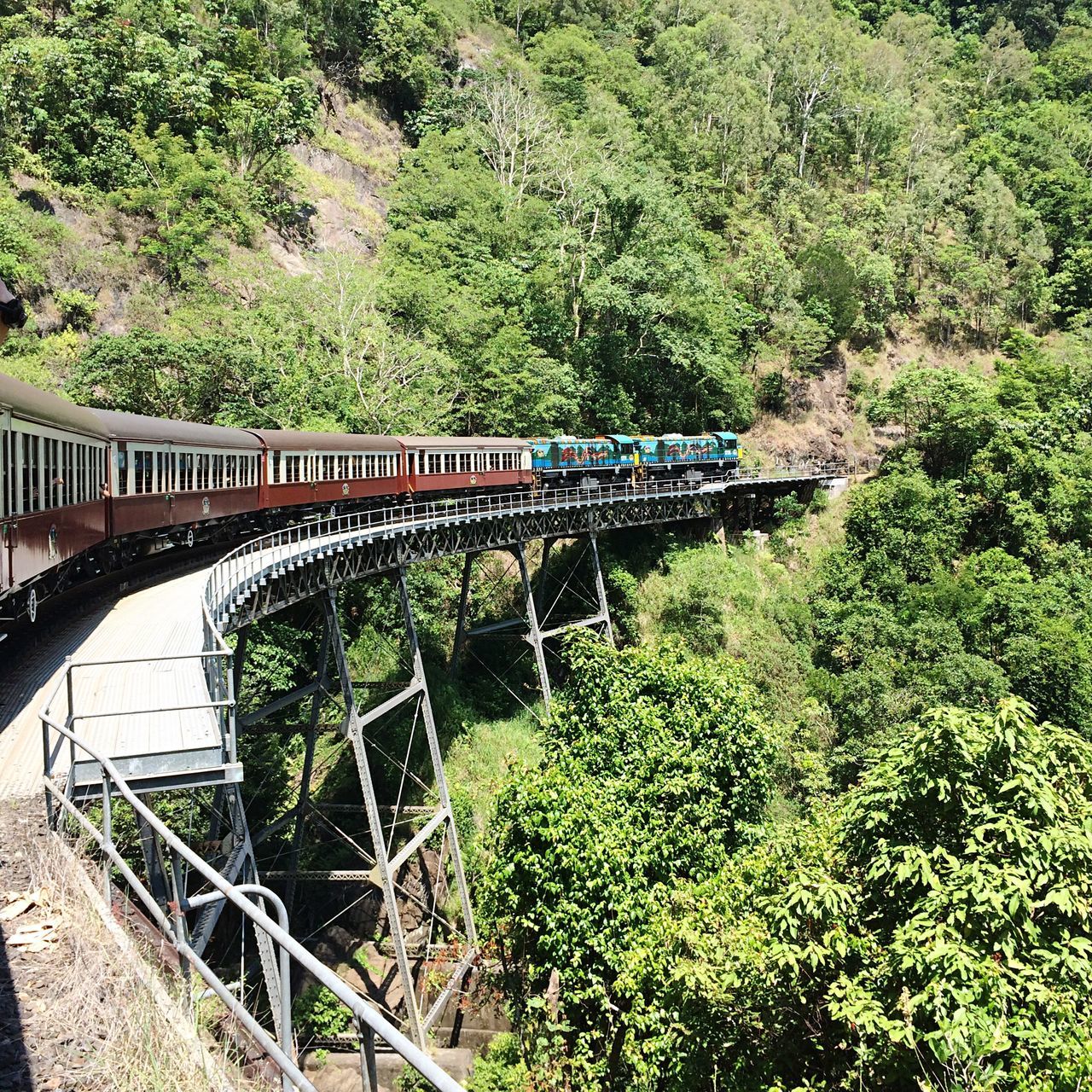 connection, bridge - man made structure, tree, water, plant, tranquility, reflection, growth, bridge, nature, day, scenics, tranquil scene, green color, canal, footbridge, travel destinations, lush foliage, non-urban scene, outdoors, remote, formal garden, arch, engineering, greenery, tourism, famous place, beauty in nature