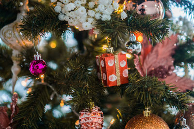 Close-up of christmas decorations hanging on tree