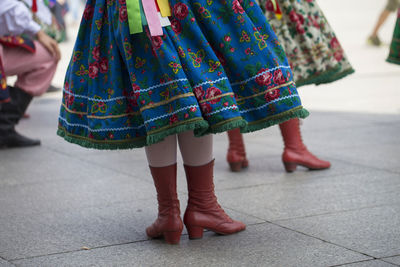 Low section of women dancing on footpath