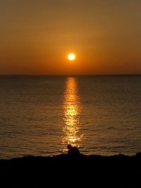 Scenic view of sea against romantic sky at sunset