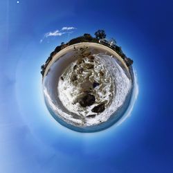 View of trees against blue sky