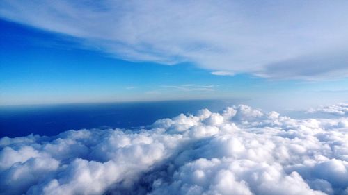 Aerial view of clouds over sea against sky