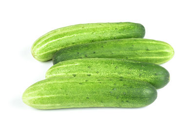 Close-up of green fruit against white background