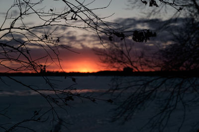 Scenic view of lake against orange sky