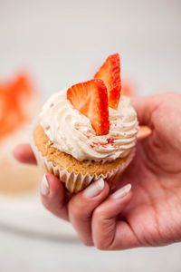 Close-up of hand holding ice cream