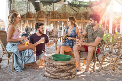 Friends enjoying cocktails at beach