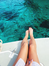 Low section of woman sitting on boat