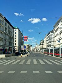 View of city street against blue sky