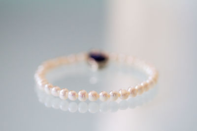 Close-up of pearl bracelet on table