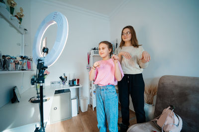 Mother and daughter record video use smartphone