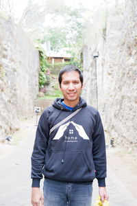 Portrait of smiling young man standing outdoors