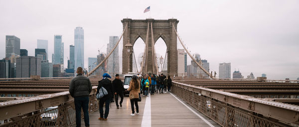 People walking on bridge in city