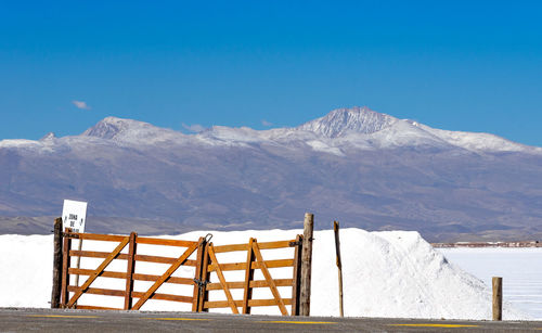 Scenic view of snowcapped mountains against blue sky