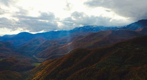 Scenic view of mountains against cloudy sky