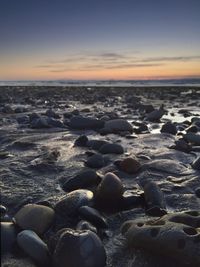 Scenic view of beach at sunset