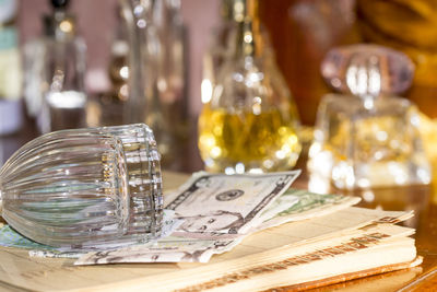 Close-up of wineglass and paper currency on table