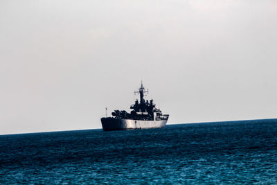 Ship sailing on sea against clear sky