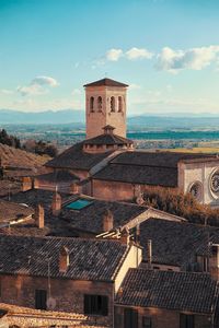 Old building in town against cloudy sky