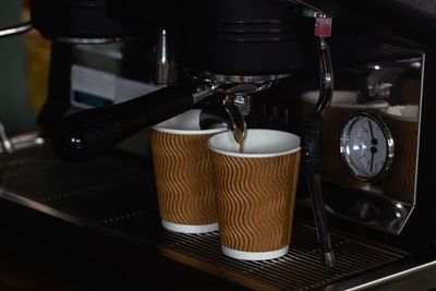 Coffee machine for fresh coffee and infusion into a paper cup, selective focus