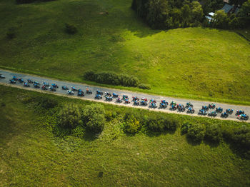 Aerial view of bike rally on road amidst field