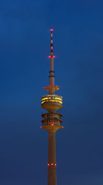 Low angle view of illuminated building against blue sky