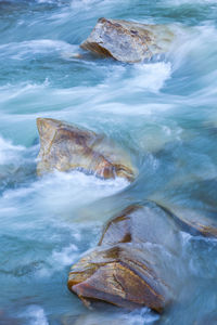 Close-up of wave on rocks at shore