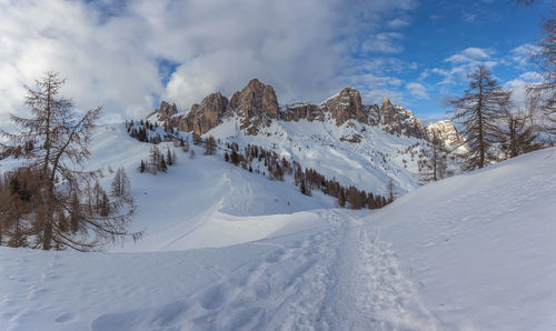 Path in the snow that leads to an area dominated by snow-capped dolomite peaks