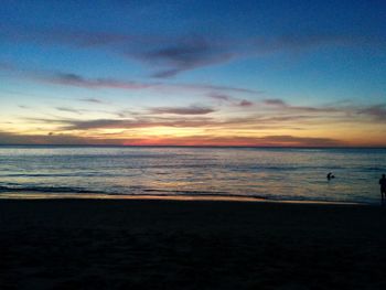 View of calm beach at sunset