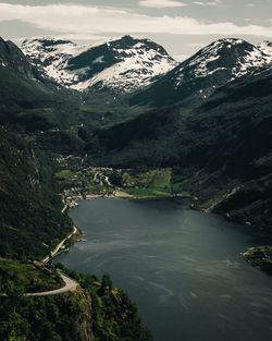 Scenic view of river amidst mountains against sky