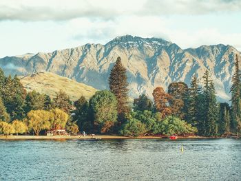 Scenic view of lake and mountains against sky