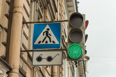 Low angle view of road sign against building