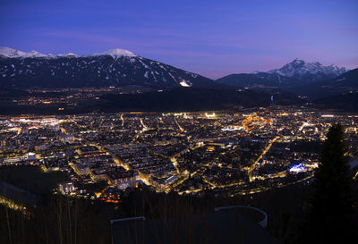 High angle view of illuminated buildings in city at night