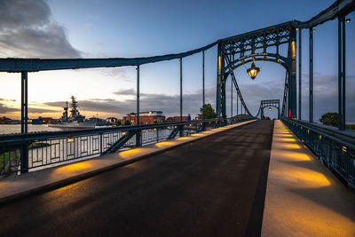 Bridge over road against sky in city