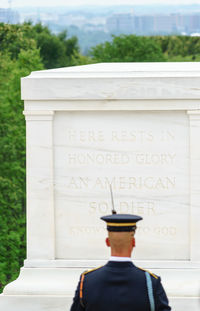 Rear view of man against built structure