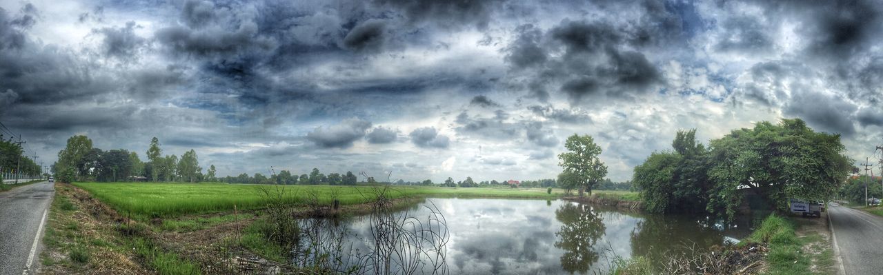 sky, cloud - sky, cloudy, water, tree, tranquility, tranquil scene, scenics, beauty in nature, nature, weather, cloud, overcast, grass, growth, storm cloud, landscape, green color, day, idyllic