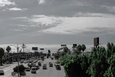 Panoramic view of city by sea against sky